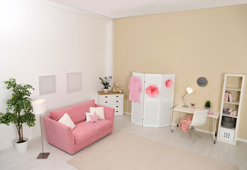 Cozy child room interior with sofa, study station and modern decor elements