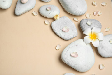 Flat lay composition with spa stones and space for text on color background