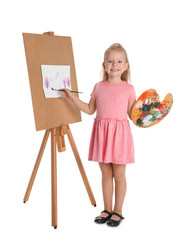 Obraz premium Child painting picture on easel against white background
