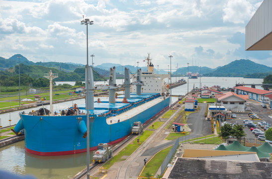 Large cargo ships pass through the Panama Canal locks.  This everyday event, provides income from both fees, and tourism, for the whole country. 