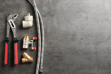 Flat lay composition with plumber's tools and space for text on gray background