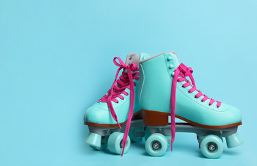 Pair of stylish quad roller skates on color background. Space for text