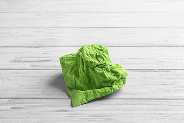 Crumpled napkin on wooden background. Personal hygiene