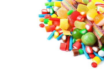 Many different yummy candies on white background. Space for text