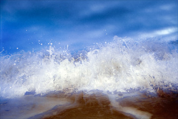 Obraz premium Close-up of incoming whitewater wave against blue sky
