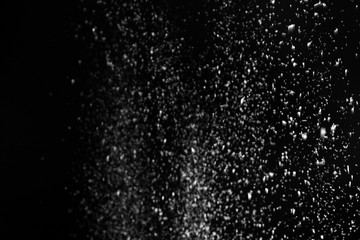 Snow flakes falling on black background. Winter weather