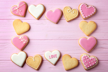 Flat lay composition with heart shaped cookies and space for text on wooden background. Valentine's...