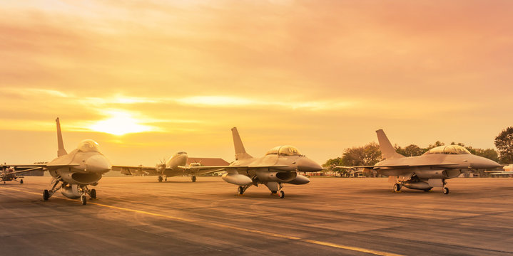 Falcon fighter jet military aircraft parked on runway in the base airforce standby ready to take off for military mission on sunset