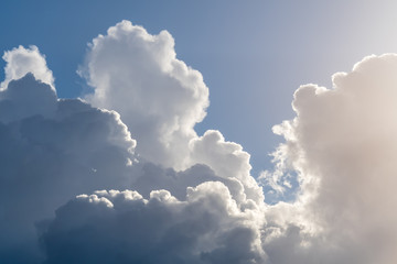Dramatic dark cloudy sky, clouds backlit by sun moving across the sky, nature background