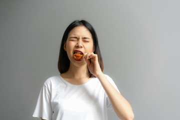 Happy woman holding fried chicken for eat.