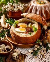 The Sour soup (Żurek) made of rye flour with sausage and eggs served in bread bowl. Traditional...