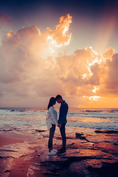 Couple in love at sunset by the sea