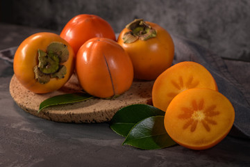 Ripe persimmon fruits in a cork plate