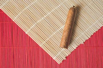 Havana cigar on white bamboo mat.