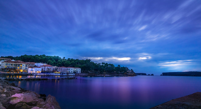 Panoramic view of the waterfront of Pylos at evening, blu hour, Greece.