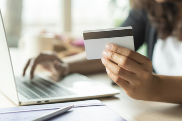close up shots hands of person shopping on ecommerce and using credit card payment via online banking.