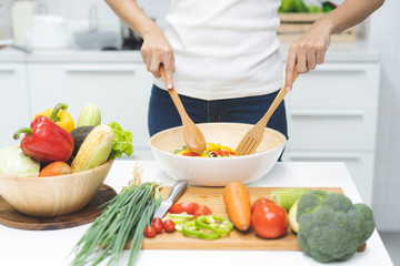 Eat healthy food for good wellness health concept. Woman cooking salad menu with fresh organic vegetables