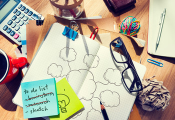 Clouds drawn in a notebook on a messy table