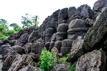 big circular rock shaped vertical located close top front & side view looking awesome.