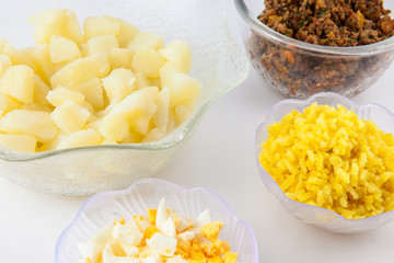 Preparation steps of traditional Colombian dish called stuffed potatoes: Cooked ingredients to prepare Colombian stuffed potatoes