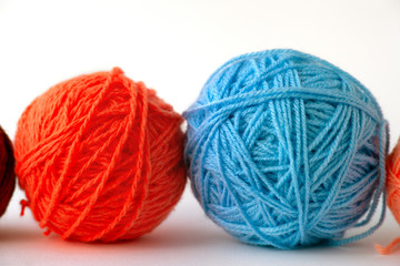 Balls of yarn on a white background. Macro. Colorful balls of yarn for knitting on a white background. Knitting is a type of needlework and hobby.