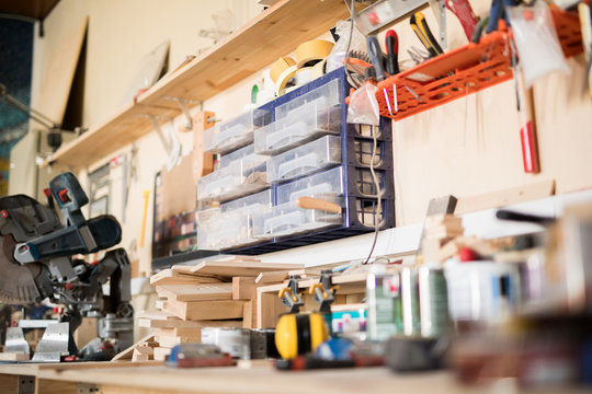 Background image of messy  workstation with different tools in modern  woodworking shop, copy space