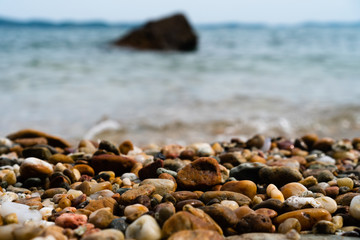 Fototapeta na wymiar Selective focus on rocks texture with blur beach for display product.