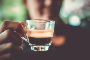 Black coffee or Americano on table with film vintage tone background.