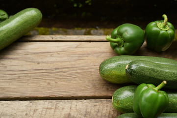 Cucumbers and sweet pepper on wooden table for background