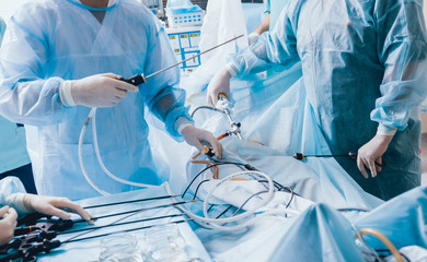 Process of gynecological surgery operation using laparoscopic equipment. Group of surgeons in...