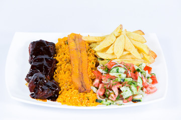 Ecuadorian national dish with rice, meat, potato, fried banana and vegetable salad