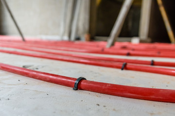 Tubes of the underfloor heating system on a styrofoam insulation