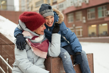 Happy mother and daughter playing outside.