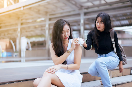 Unhappy female support her girl friend,Friends giving tissue to depressed asian woman,Mental health care concept