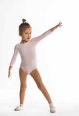 The little girl of four years is engaged in gymnastics