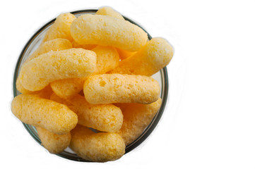 Corn Puffs in a Glass Bowl Isolated On White Background. Crunchy Flavored Puffed Snacks. Party, Movie Snacks.