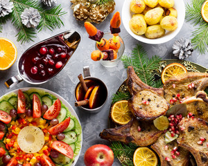 Christmas dinner with roasted meat steak, Christmas Wreath salad, baked potato, grilled vegetables, cranberry sauce.
