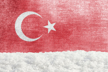 Winter grunge background with snowdrift and Turkish flag in the backdrop