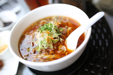 Japanese noodles in white bowl with a spoon