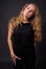 Naklejka premium Young beautiful businesswoman with long wavy blond hair against 