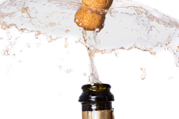 Cork flying from a champagne bottle under the pressure of a liquid