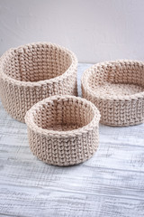 Fototapeta premium Knitted baskets of cord on a white background