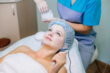 Young pretty woman enjoying a facial mask procedure