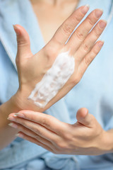 Anti Age Hand Care. Woman's hands with applying cream