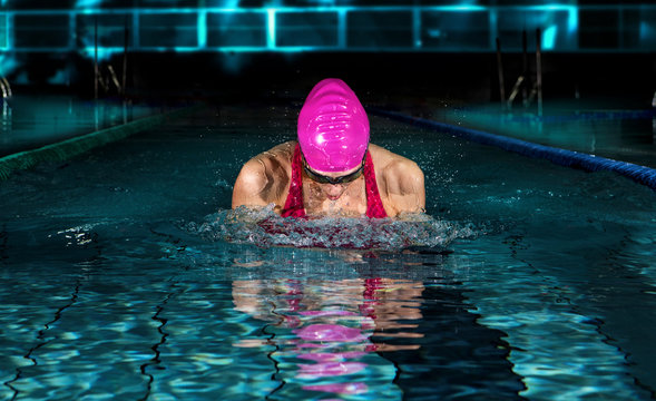Professional woman in swimming pool. Breaststroke  swimming style
