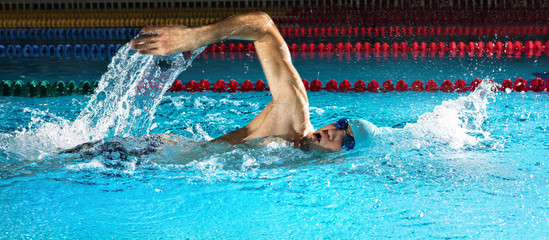 Man in swimming pool. Crawl swimming style