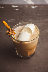Sweet hot chocolate in glass. Christmas drink with spices and marshmallow. Selective focus. Shallow depth of field. 