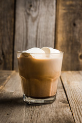 Sweet hot chocolate in glass. Christmas drink with spices and marshmallow. Selective focus. Shallow depth of field. 