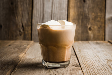 Sweet hot chocolate in glass. Christmas drink with spices and marshmallow. Selective focus. Shallow depth of field. 