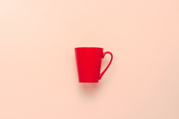 Red dagger on a pink background. The concept of hot coffee or tea. Flat lay, top view